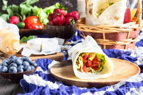 Fresh tortilla wraps with roasted chicken and vegetables. Ideas for picnic. Stock Photos