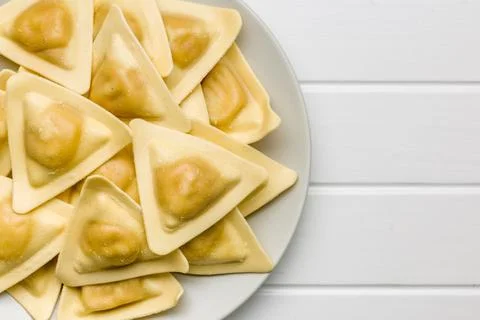 Fresh Triangular Ravioli Pasta on Plate Close-Up Italian Homemade Dumplings.. Fotos de archivo