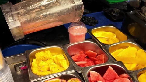 Fresh Tropical Fruit Smoothie Being Poured at Street Market Stock Footage 337420937