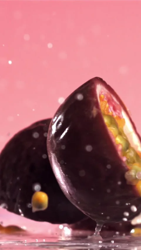 Fresh tropical passion fruit falls on a wet table. Filmed on a high-speed camera Stock Footage 335321989