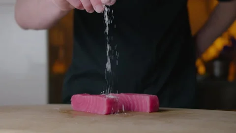 Fresh tuna sprinkled with sea salt. Slow Motion. In the restaurant Stock Footage