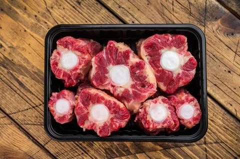 Fresh uncooked mutton lamb oxtail cuts with marrow bones packaged in tray, .. Stock Photos
