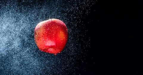 Fresh  Variegated apple  gets sprayed with water on black background. Concept 스톡 사진