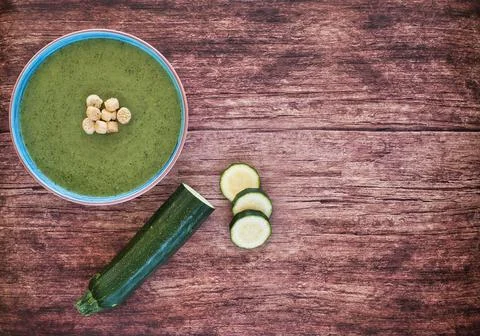 Fresh vegetable detox soup made from peas in a plate on brown wooden table wi Foto stock