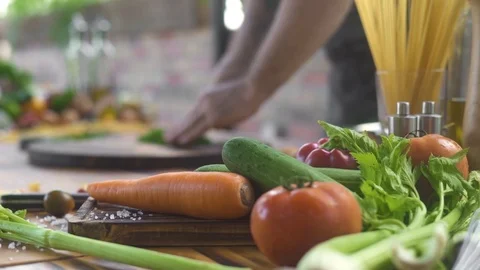 Fresh vegetable on kitchen table. Chef cook cutting greenery on food background Stock Footage 105156517