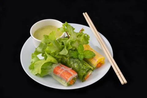 Fresh vegetable noodle spring roll with sauce on plate, Salad roll, On a blac Stock Photos