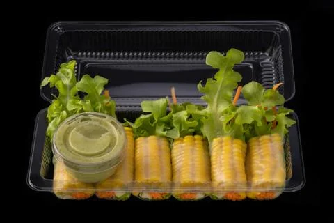 Fresh vegetable noodle spring roll with sauce in box, Salad roll, On a black  Stock Photos