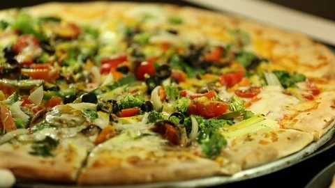 Fresh vegetable or veggie pizza from brick oven Stock Footage 123874855