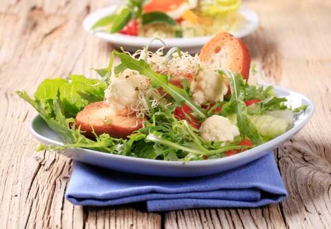 Fresh vegetable salad with crispy bread rounds Stock Photos
