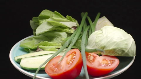 Fresh vegetable salad from cucumber, tomato, spinach, cabbage, lettuce and onion Video stock 244491570