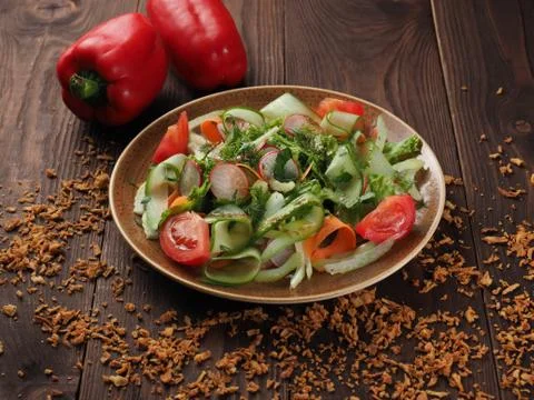 Fresh vegetable salad in a plate on the table Stock Photos