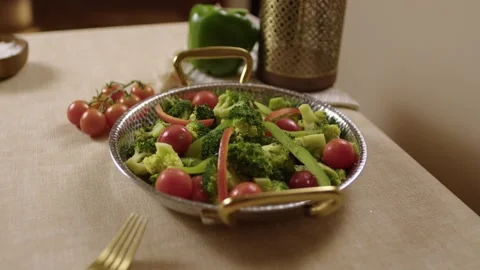 Fresh Vegetable Salad with Tomatoes and Broccoli on Elegant Dining Table Indoors Stock Footage 345277192