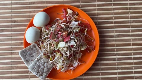 A fresh vegetable salad. Tomatoes, eggs, bread rolls, onions, apples, mound of Stock Footage 316805557