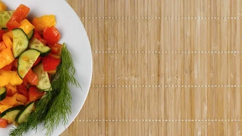 Fresh vegetable salad, top view. A plate with a salad of tomatoes and cucumbe Stock Footage 95475414