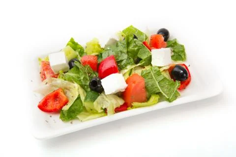 Fresh vegetable salad on white rectangular plate isolated on white background Stock-Fotos