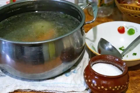 Fresh vegetable soup in pan on the table Stock Photos