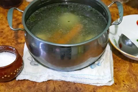 Fresh vegetable soup in pan on the table Stock Photos