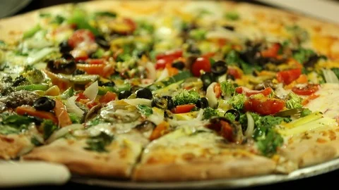 Fresh vegetable supreme or veggie pizza from brick oven Stock Footage 123874878