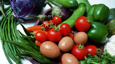 Fresh Vegetables and Eggs in a Basket, A vibrant assortment of fresh vegeta.. 動画素材 305038918