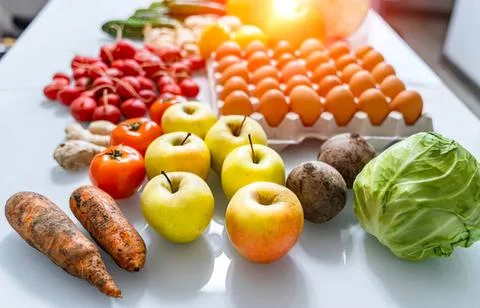 Fresh vegetables and eggs on a kitchen table Stock Photos