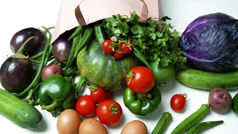 Fresh Vegetables and Eggs Spilling from a Paper Bag, A variety of fresh veg.. Stock Footage 305053408