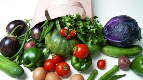 Fresh Vegetables and Eggs Spilling from a Paper Bag, A variety of fresh veg.. 库存影片 305053437