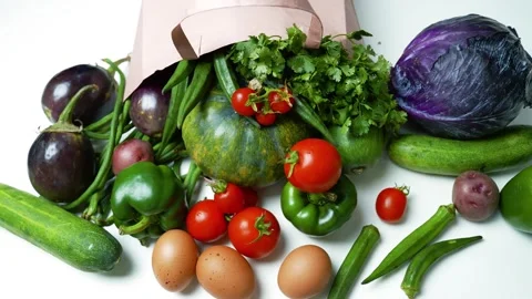 Fresh Vegetables and Eggs Spilling from a Paper Bag, A variety of fresh veg.. Stockbeeldmateriaal 305053570