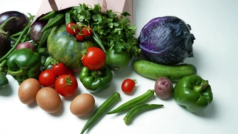 Fresh Vegetables and Eggs Spilling from a Paper Bag, A variety of fresh veg.. Vídeos de archivo 305053596
