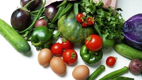 Fresh Vegetables and Eggs Spilling from a Paper Bag, A variety of fresh veg.. Stockbeeldmateriaal 305053671