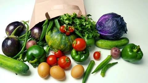 Fresh Vegetables and Eggs Spilling from Paper Bag, A variety of fresh veget.. Stock Footage 305053722