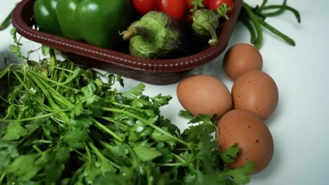 Fresh Vegetables and Eggs on White Surface, A collection of fresh vegetable.. Stock Footage 305029151