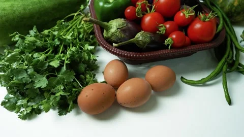 Fresh Vegetables and Eggs on White Surface Footage, A variety of fresh vege.. Stock Footage 305029196