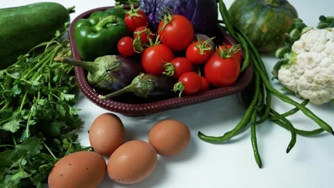 Fresh Vegetables and Eggs on White Surface Footage, A variety of fresh vege.. 動画素材 305029271
