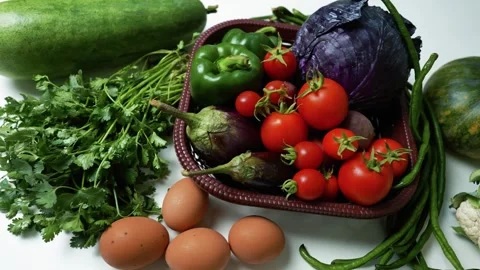 Fresh Vegetables and Eggs on White Surface Footage, A variety of fresh vege.. Stockbeeldmateriaal 305029343