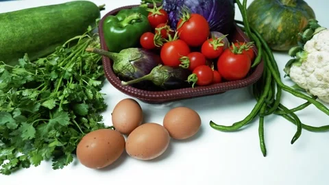 Fresh Vegetables and Eggs on White Surface, A variety of fresh vegetables a.. Stock Footage 305029385