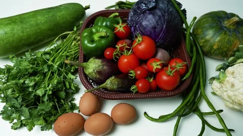 Fresh Vegetables and Eggs on White Surface, A variety of fresh vegetables a.. 動画素材 305029430