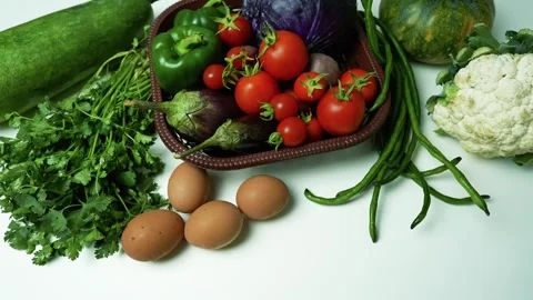 Fresh Vegetables and Eggs on White Surface, A variety of fresh vegetables a.. Stockbeeldmateriaal 305029503