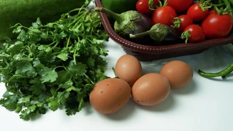 Fresh Vegetables and Eggs on White Surface, A collection of fresh vegetable.. 動画素材 305030308