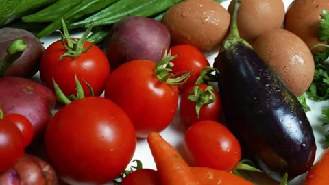 Fresh Vegetables and Eggs on White Surface, A variety of fresh vegetables a.. Видео 305032679