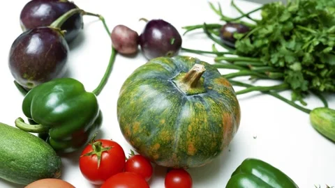 Fresh Vegetables and Eggs on White Surface, A variety of fresh vegetables a.. 스톡 동영상 305060296