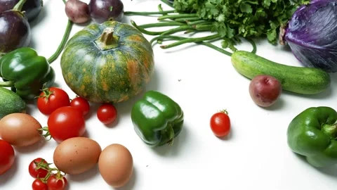 Fresh Vegetables and Eggs on White Surface, A variety of fresh vegetables a.. Vidéo 305060339