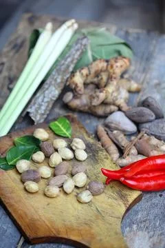 Fresh vegetables and herbs on a rustic wooden cutting board Stock Photos