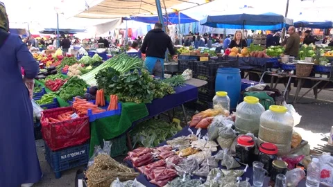 Fresh vegetables and spices counter at an open-air farmer market Stock-Footage 342725344