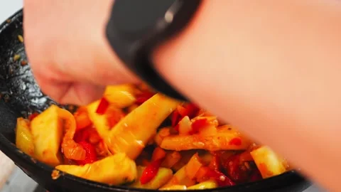Fresh vegetables are being skillfully combined in a warm kitchen. Bright peppers 動画素材 316485456