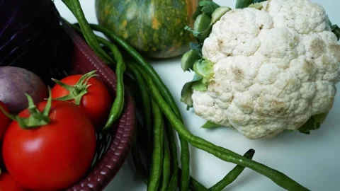 Fresh Vegetables Assortment on White Surface, A variety of fresh vegetables.. Stock Footage 305033372