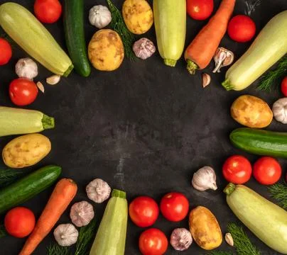 Fresh vegetables on the black background in flat lay design. Vegan concept Stock Photos