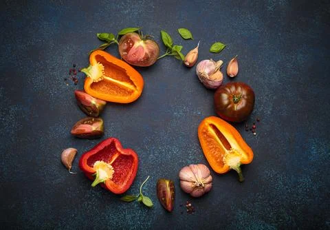 Fresh vegetables creating a circle on a textured blue background, top view with Stock Photos
