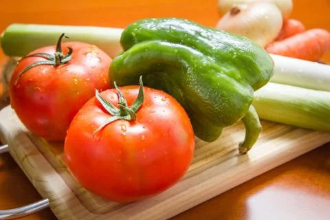 Fresh vegetables on cutting board in the kitchen Stock Photos