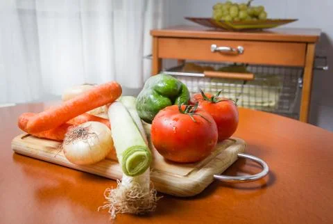 Fresh vegetables on cutting board in the kitchen Stock Photos