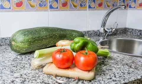Fresh vegetables on cutting board in the kitchen Stock Photos